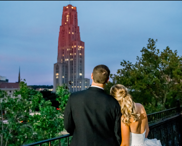 bride and groom on terrace looking at Cathedral in distance