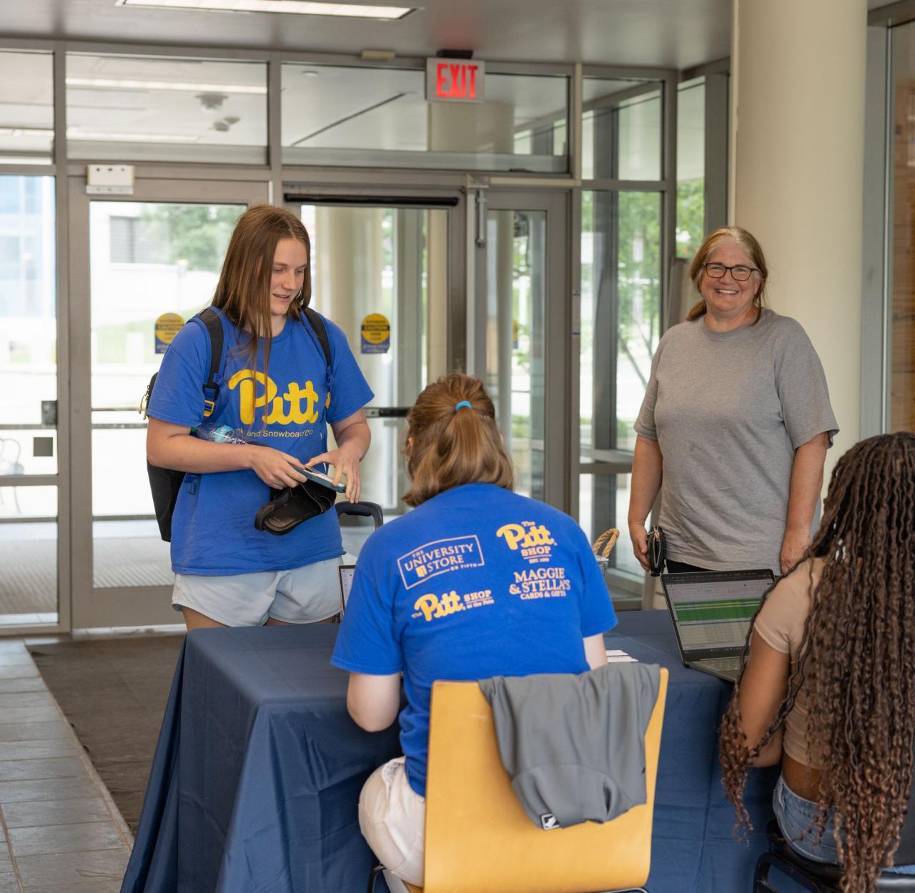 Student checking in at desk for camp